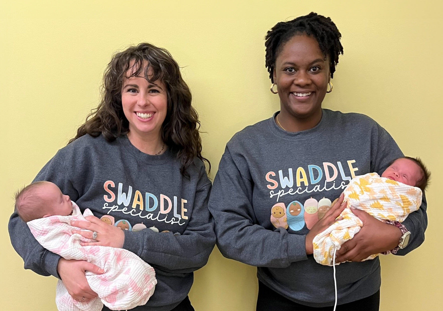 nurses holding babies